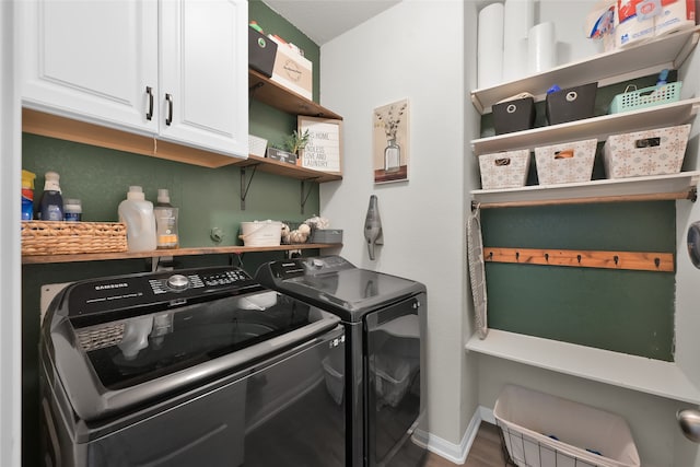 washroom featuring cabinets and separate washer and dryer