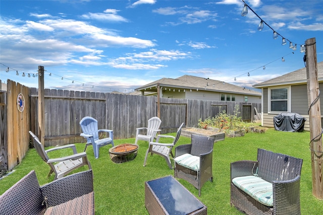 view of yard with a fire pit