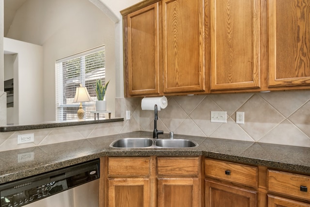 kitchen featuring stainless steel dishwasher, sink, and tasteful backsplash