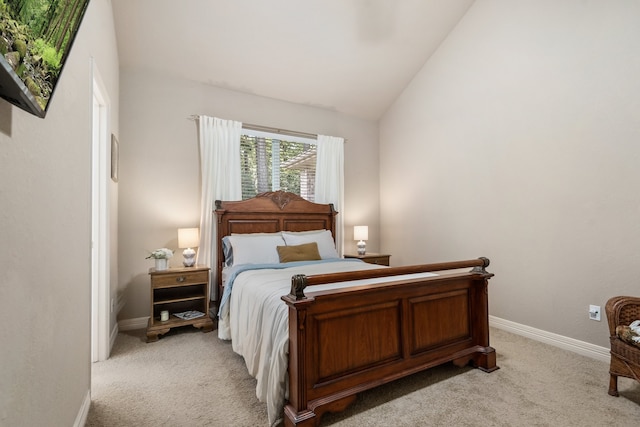 bedroom featuring lofted ceiling and light colored carpet