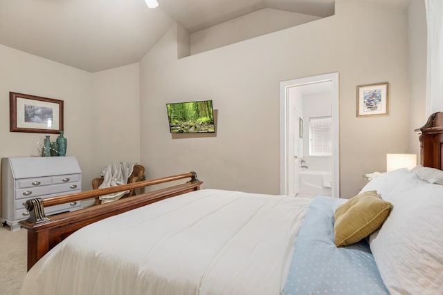 carpeted bedroom with ensuite bath and vaulted ceiling