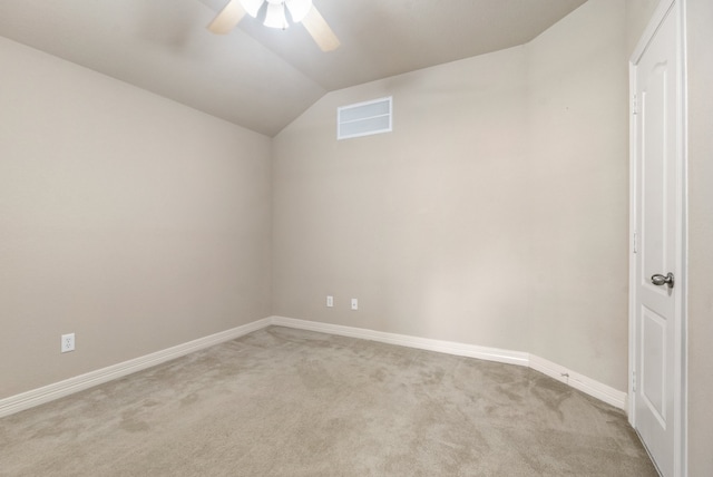 carpeted empty room with vaulted ceiling and ceiling fan