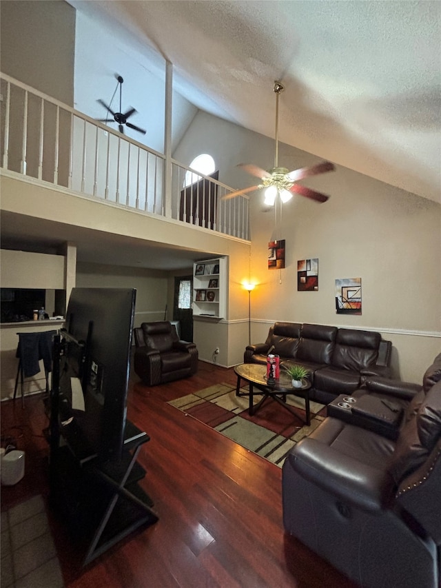 living room featuring a textured ceiling, high vaulted ceiling, wood-type flooring, and ceiling fan