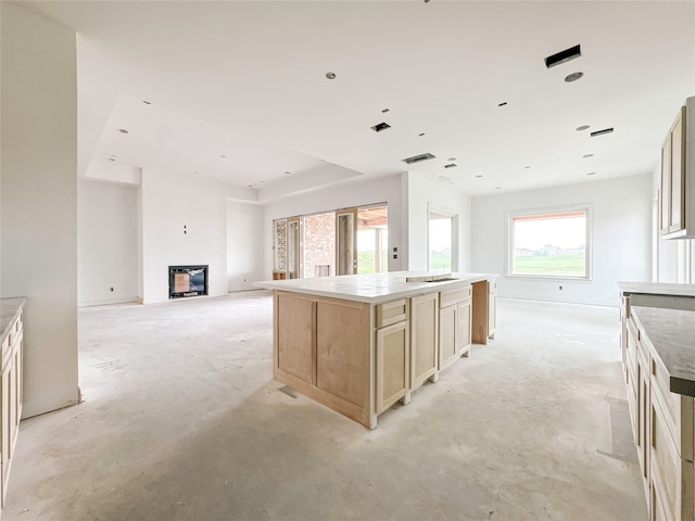 kitchen featuring a kitchen island and light brown cabinets