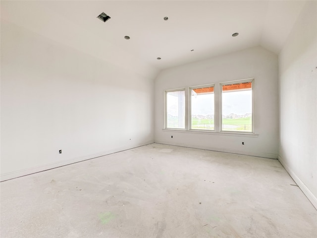 unfurnished room featuring lofted ceiling