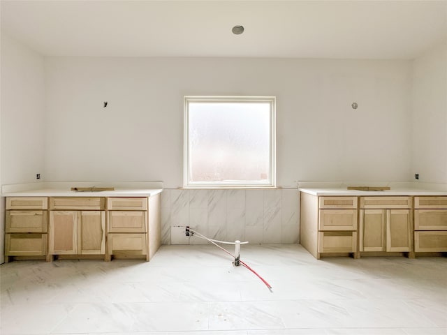 interior space featuring tile walls and sink