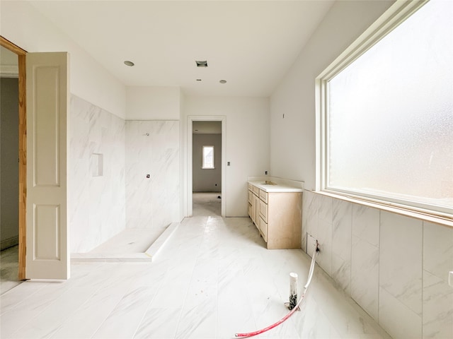 bathroom with vanity and walk in shower