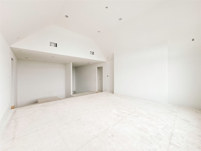 spare room featuring lofted ceiling