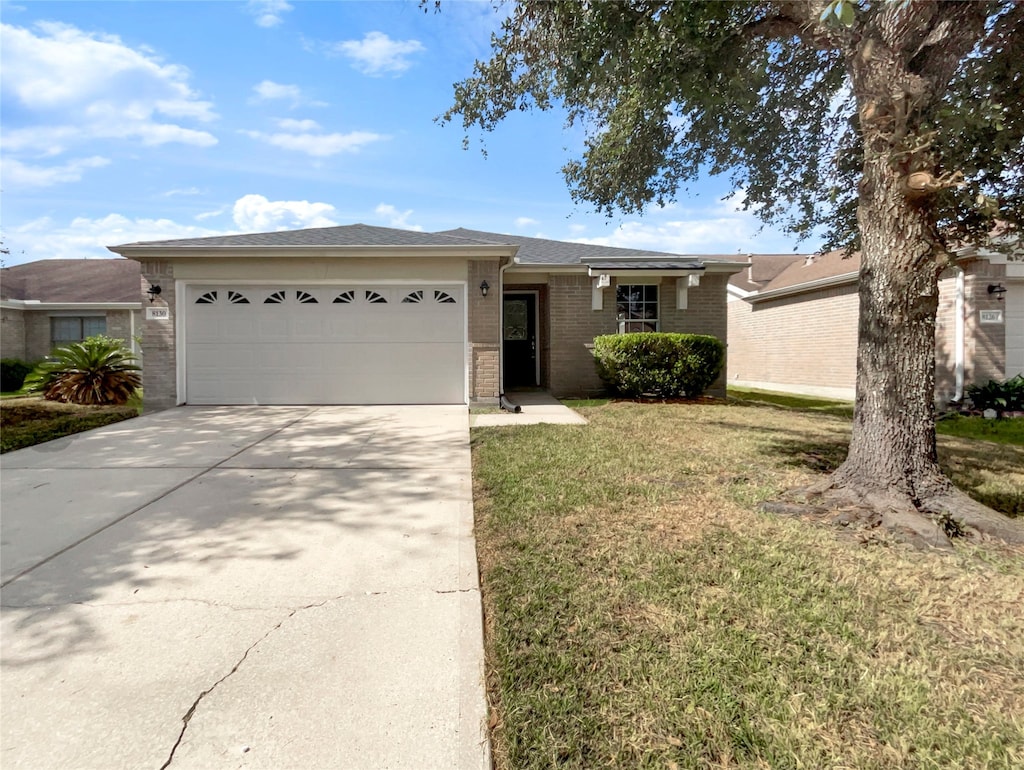 single story home with a garage and a front yard