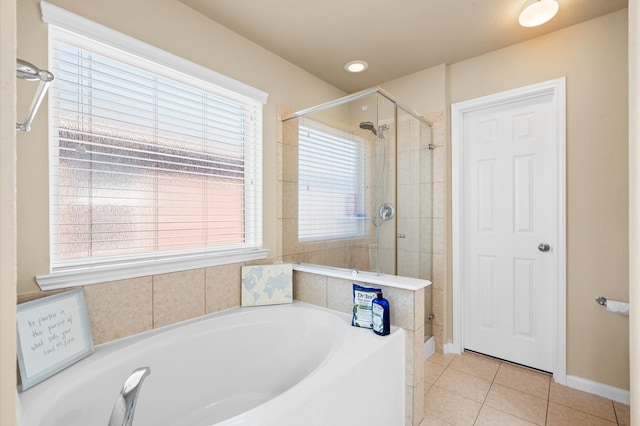 bathroom featuring a healthy amount of sunlight, independent shower and bath, and tile patterned flooring