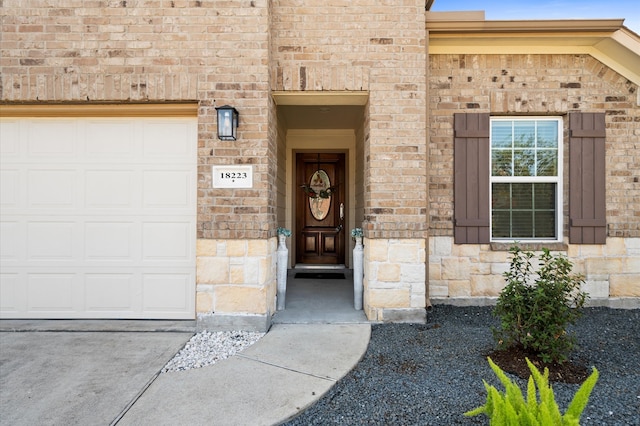 view of exterior entry with a garage