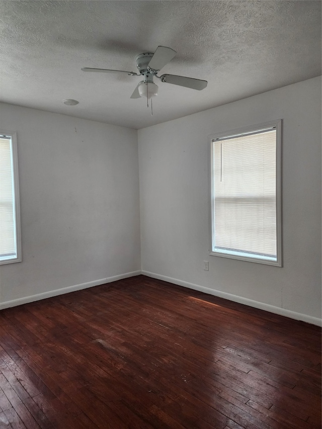 spare room featuring a textured ceiling, ceiling fan, and dark hardwood / wood-style floors