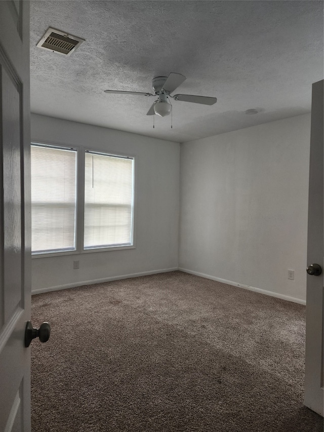 unfurnished room featuring a textured ceiling, carpet flooring, and ceiling fan