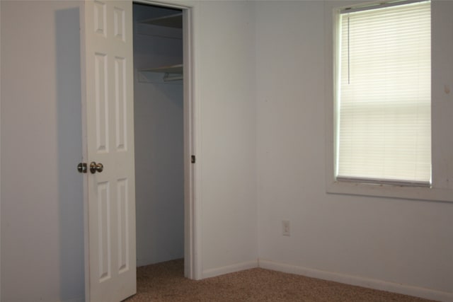 unfurnished bedroom with carpet and a closet