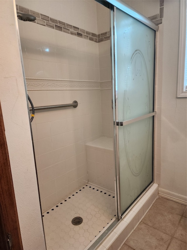 bathroom featuring tile patterned flooring and a shower with door