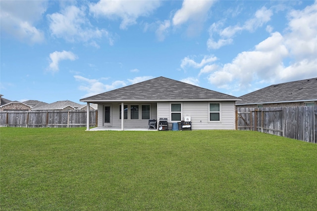 rear view of property featuring a yard and a patio