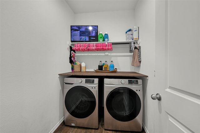 clothes washing area featuring washing machine and dryer and dark hardwood / wood-style floors