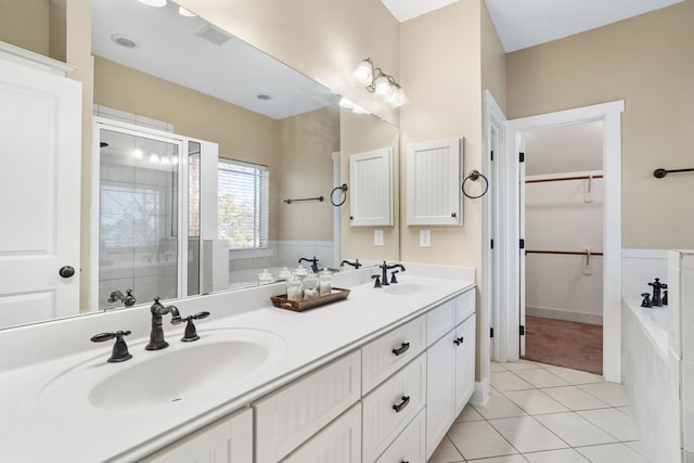 bathroom featuring tile patterned flooring, vanity, and plus walk in shower