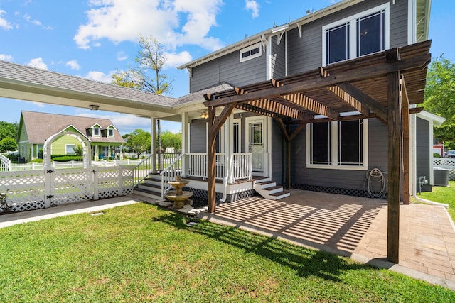 back of house with a pergola, a patio area, and a yard