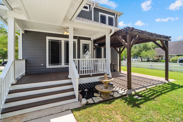 view of exterior entry with covered porch, a pergola, and a lawn