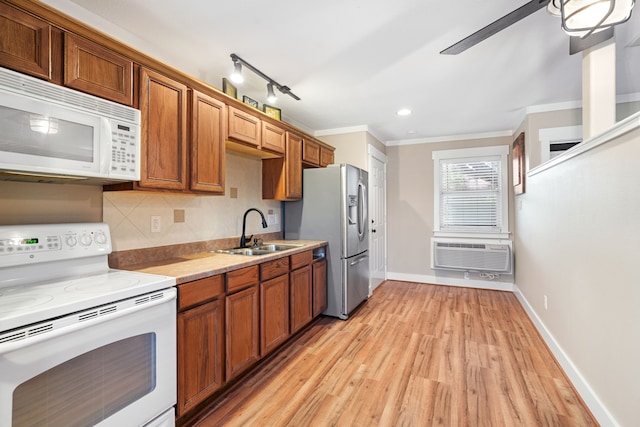 kitchen with sink, tasteful backsplash, light hardwood / wood-style floors, white appliances, and ornamental molding