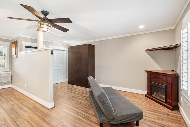 office with ceiling fan, crown molding, and light hardwood / wood-style flooring