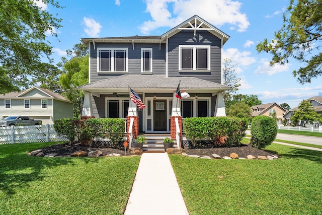 view of front of house featuring covered porch and a front yard