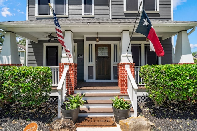 view of exterior entry featuring ceiling fan and a porch