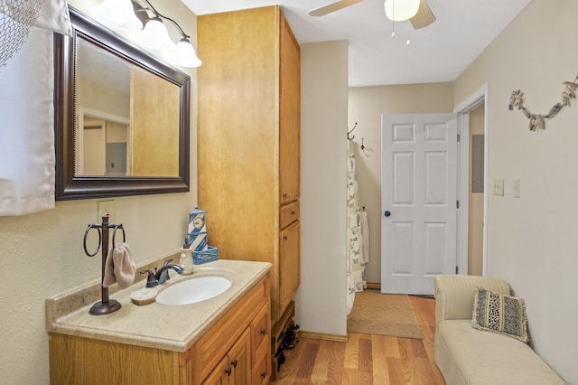 bathroom with wood-type flooring, ceiling fan, and vanity