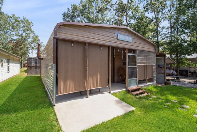 rear view of property featuring a lawn