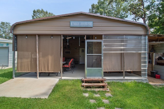 rear view of property featuring a yard