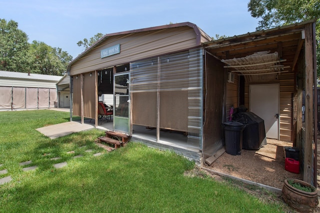 rear view of property with a sunroom and a lawn