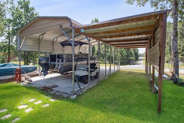 view of vehicle parking with a yard and a carport