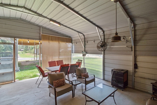 sunroom featuring heating unit and vaulted ceiling