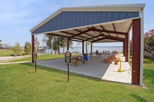 view of property's community with a water view, a yard, and a gazebo