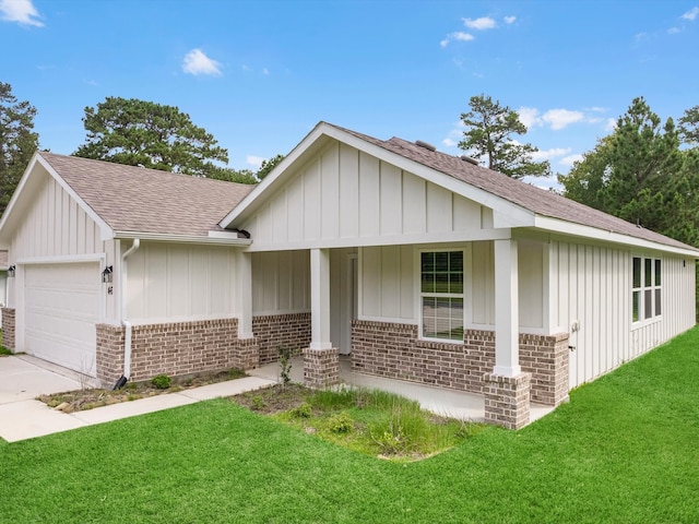 ranch-style house featuring a garage, a front yard, and a porch