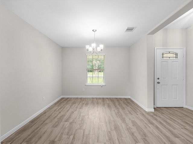 interior space with a notable chandelier and light hardwood / wood-style floors