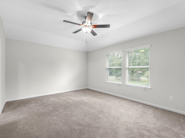 unfurnished room featuring vaulted ceiling, light colored carpet, and ceiling fan