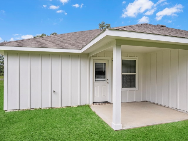 doorway to property with a yard and a patio area