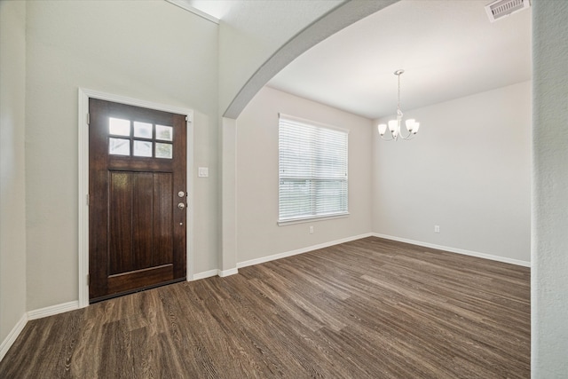 foyer with dark hardwood / wood-style flooring and a notable chandelier