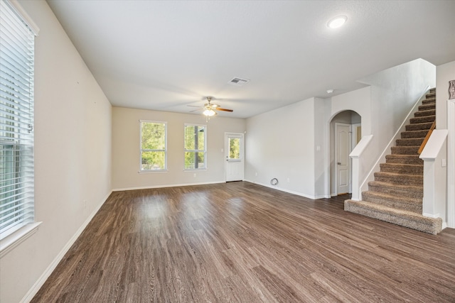 unfurnished living room with ceiling fan and dark hardwood / wood-style flooring