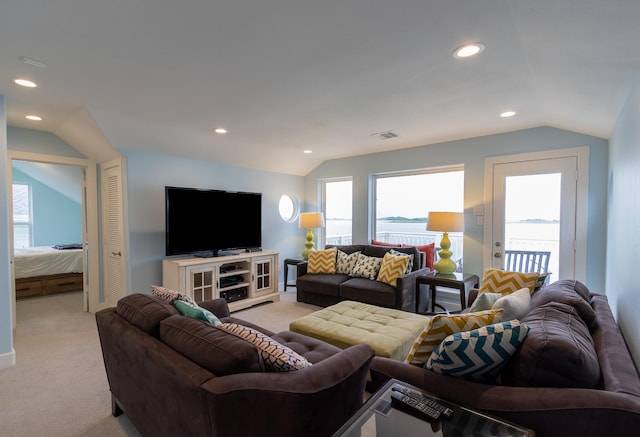 living room featuring light colored carpet and vaulted ceiling