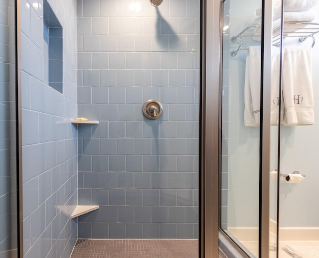 bathroom featuring a shower with door