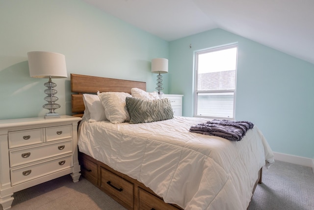 carpeted bedroom with lofted ceiling