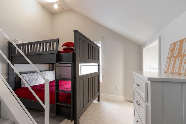 bedroom featuring light carpet and vaulted ceiling