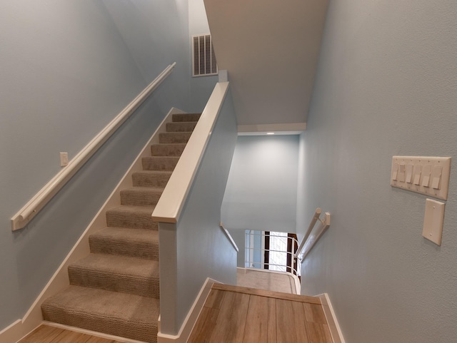 stairs with hardwood / wood-style floors