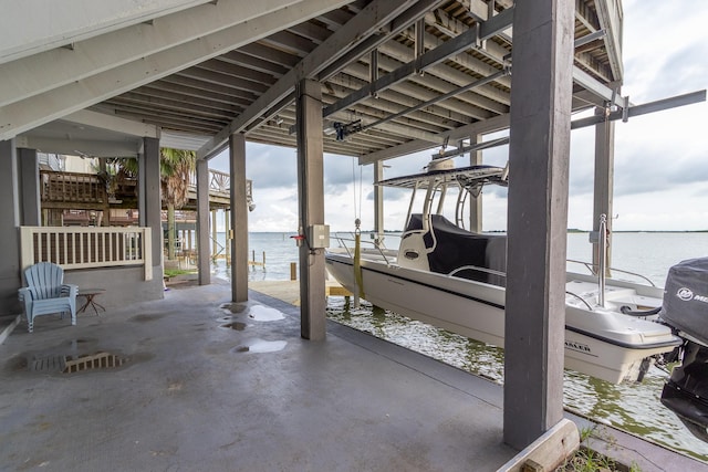 view of patio featuring a water view and a boat dock