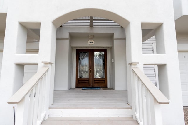 view of exterior entry featuring french doors