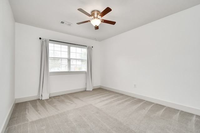 unfurnished room featuring light colored carpet and ceiling fan