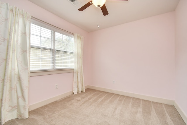 spare room with light carpet and ceiling fan